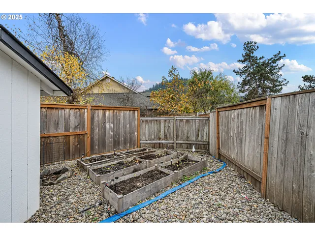 a view of a backyard with a wooden fence