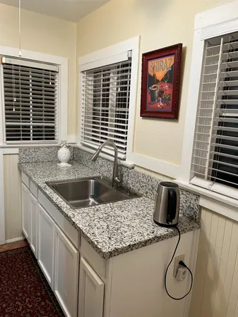 a kitchen with granite countertop a stove and a sink