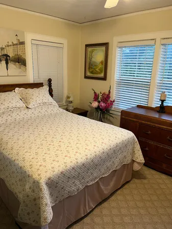 a bed sitting in a bedroom next to a window