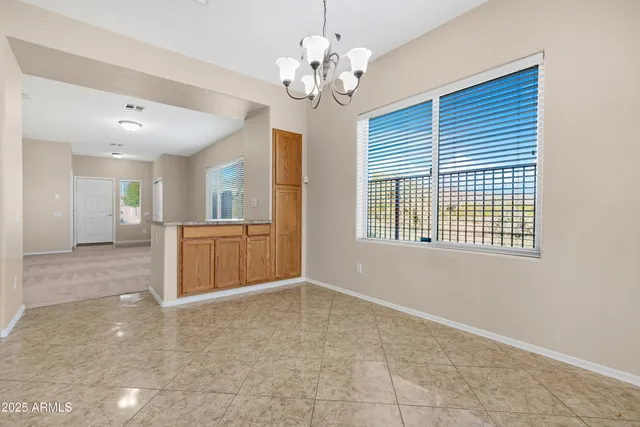 a view of a kitchen with granite countertop a sink and a chandelier