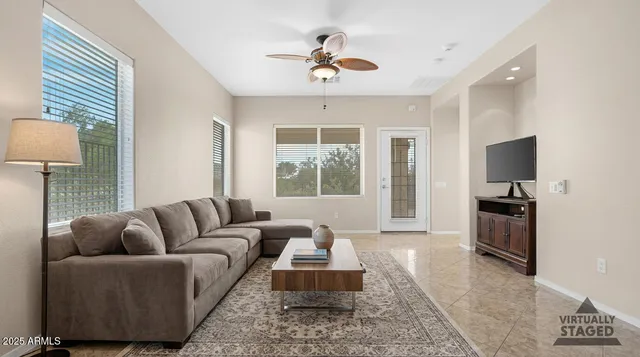 a living room with furniture a window and a flat screen tv