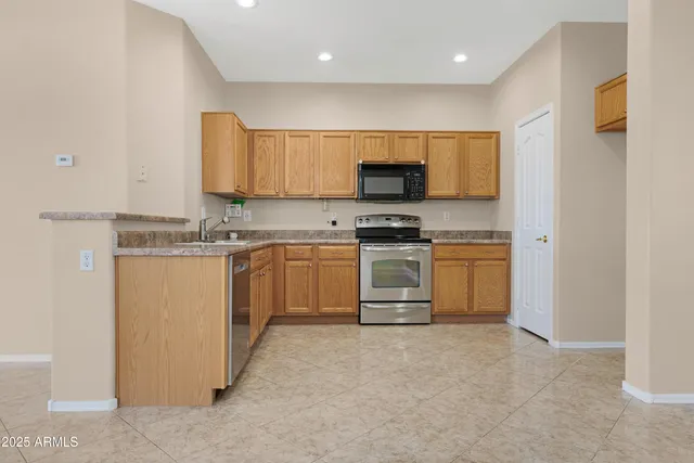 a kitchen with a stove top oven and white stainless steel appliances