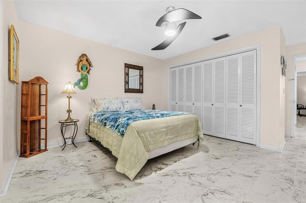 610 Indian Rocks Road North, Unit 103 Belleair Bluffs, FL 33770 - Photo 14 of 23 a bedroom with a bed and a painting on the wall