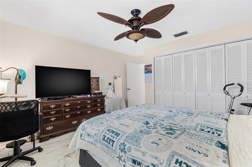 610 Indian Rocks Road North, Unit 103 Belleair Bluffs, FL 33770 - Photo 19 of 23 a bedroom with a bed and a flat screen tv