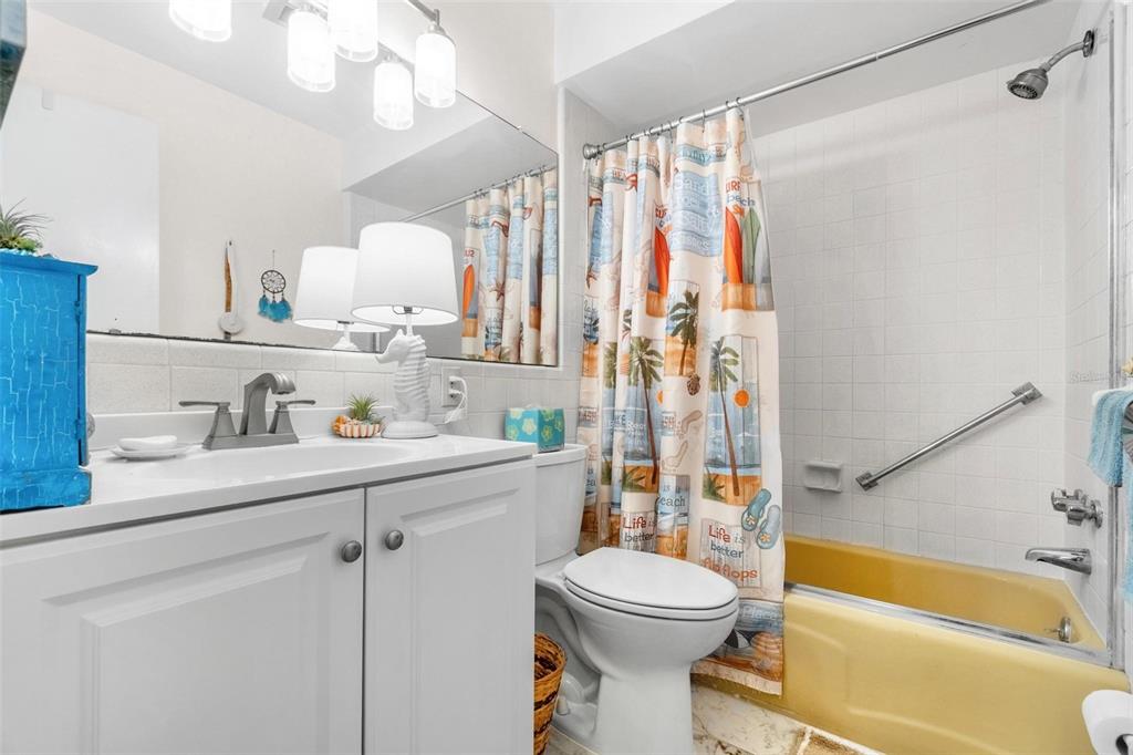 610 Indian Rocks Road North, Unit 103 Belleair Bluffs, FL 33770 - Photo 20 of 23 a bathroom with a sink a toilet and a bathtub