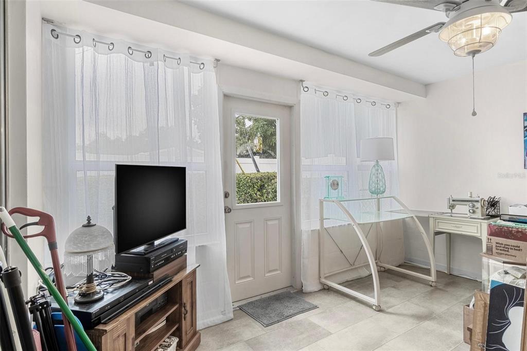 610 Indian Rocks Road North, Unit 103 Belleair Bluffs, FL 33770 - Photo 21 of 23 a living room with furniture and a flat screen tv