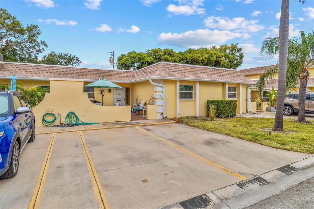 610 Indian Rocks Road North, Unit 103 Belleair Bluffs, FL 33770 - Photo 3 of 23 a view of a white house with a outdoor space