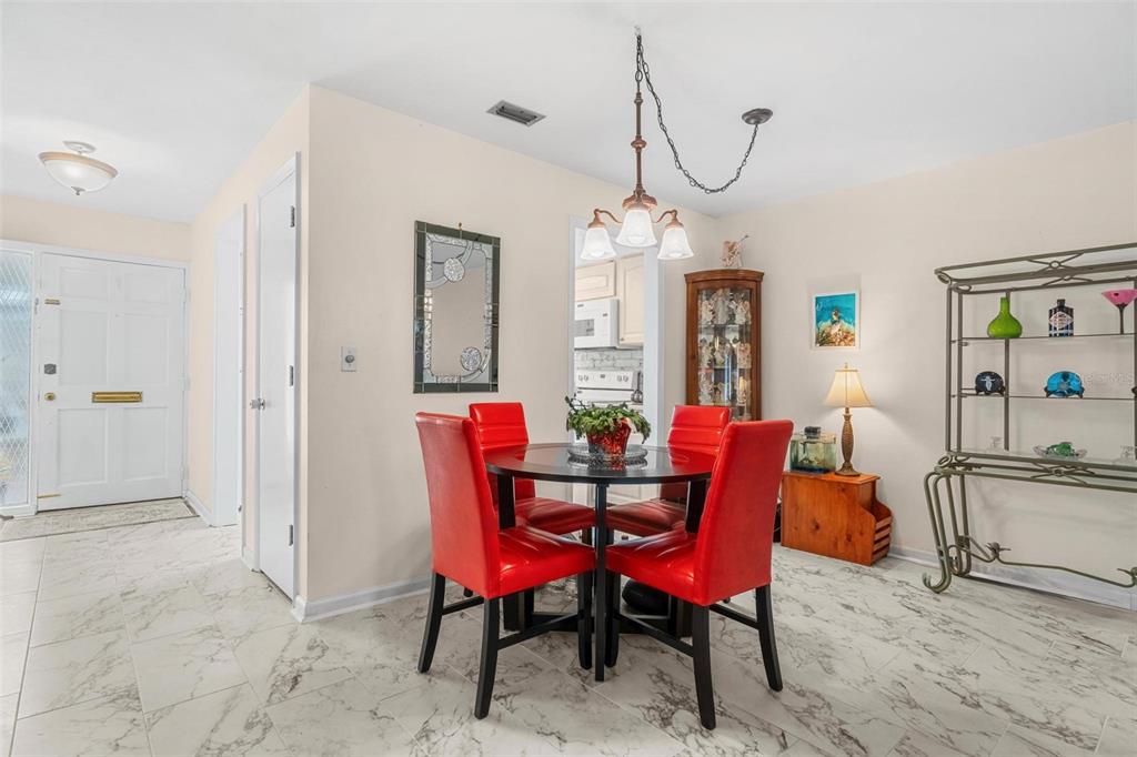 610 Indian Rocks Road North, Unit 103 Belleair Bluffs, FL 33770 - Photo 7 of 23 a view of a dining room with furniture