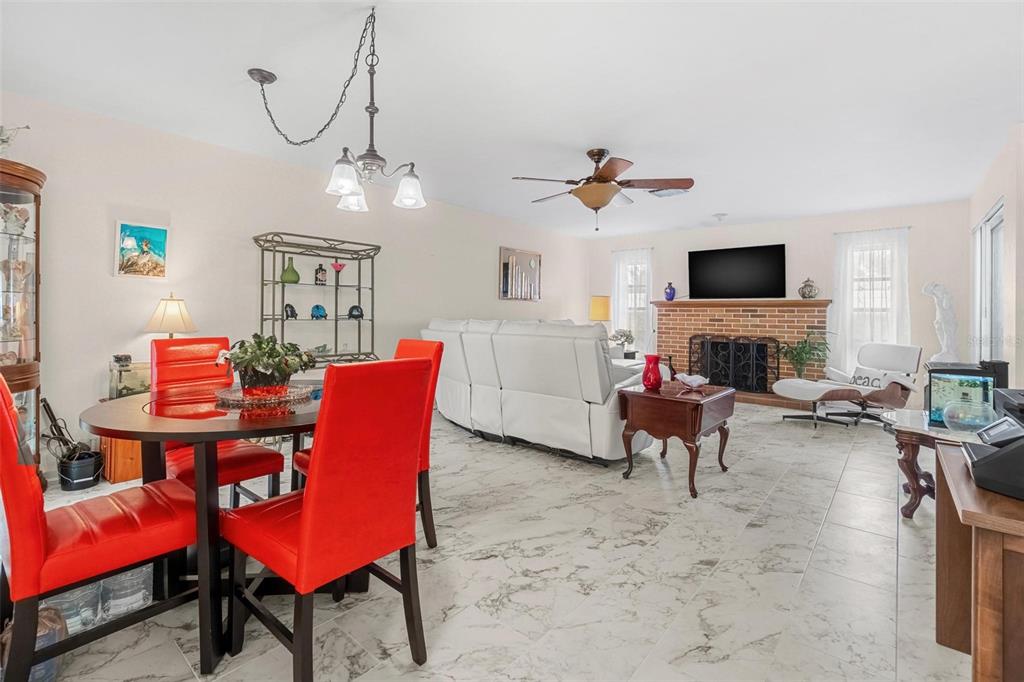 610 Indian Rocks Road North, Unit 103 Belleair Bluffs, FL 33770 - Photo 8 of 23 a living room with furniture a fireplace and a flat screen tv