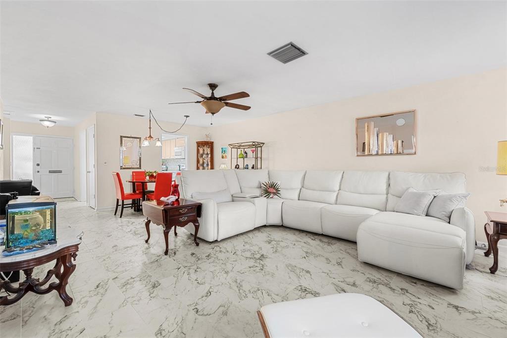 610 Indian Rocks Road North, Unit 103 Belleair Bluffs, FL 33770 - Photo 9 of 23 a living room with furniture and a large window