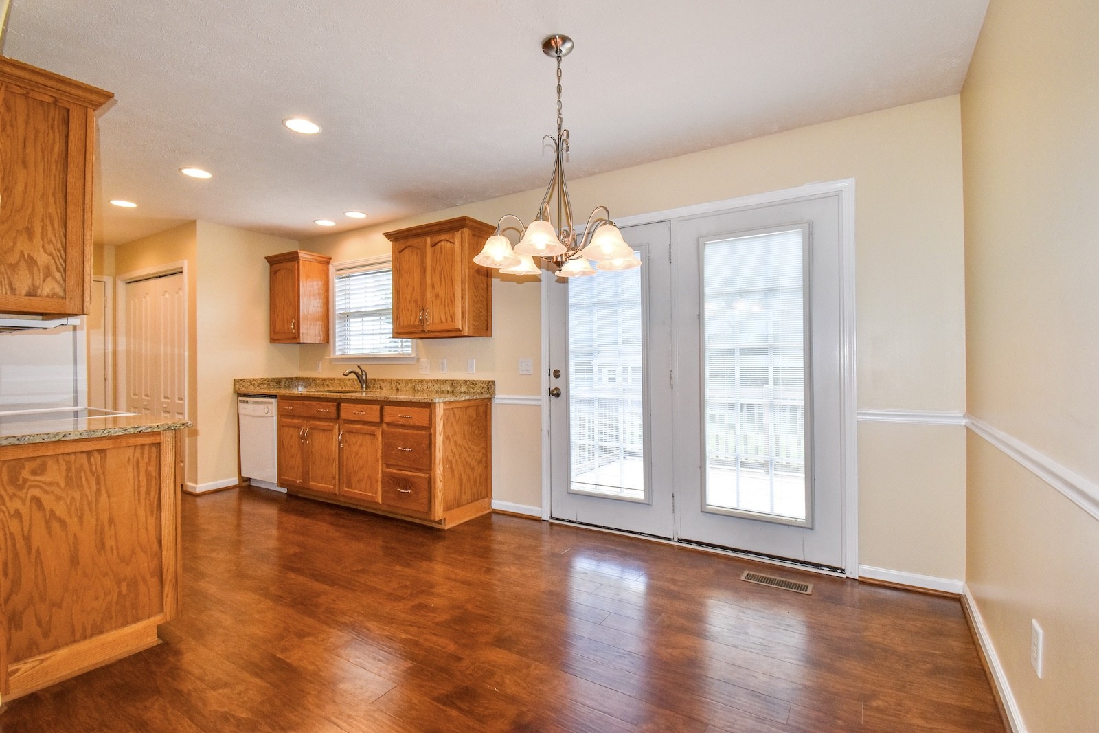 1621 Robert Road Columbia, TN 38401 - Photo 7 of 34 a kitchen with stainless steel appliances granite countertop a stove a sink and white cabinets with wooden floor