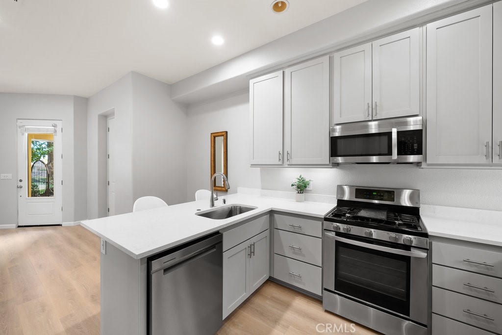 1156 Spring Azure Way Nipomo, CA 93444 - Photo 11 of 60 a kitchen with a sink stove and microwave