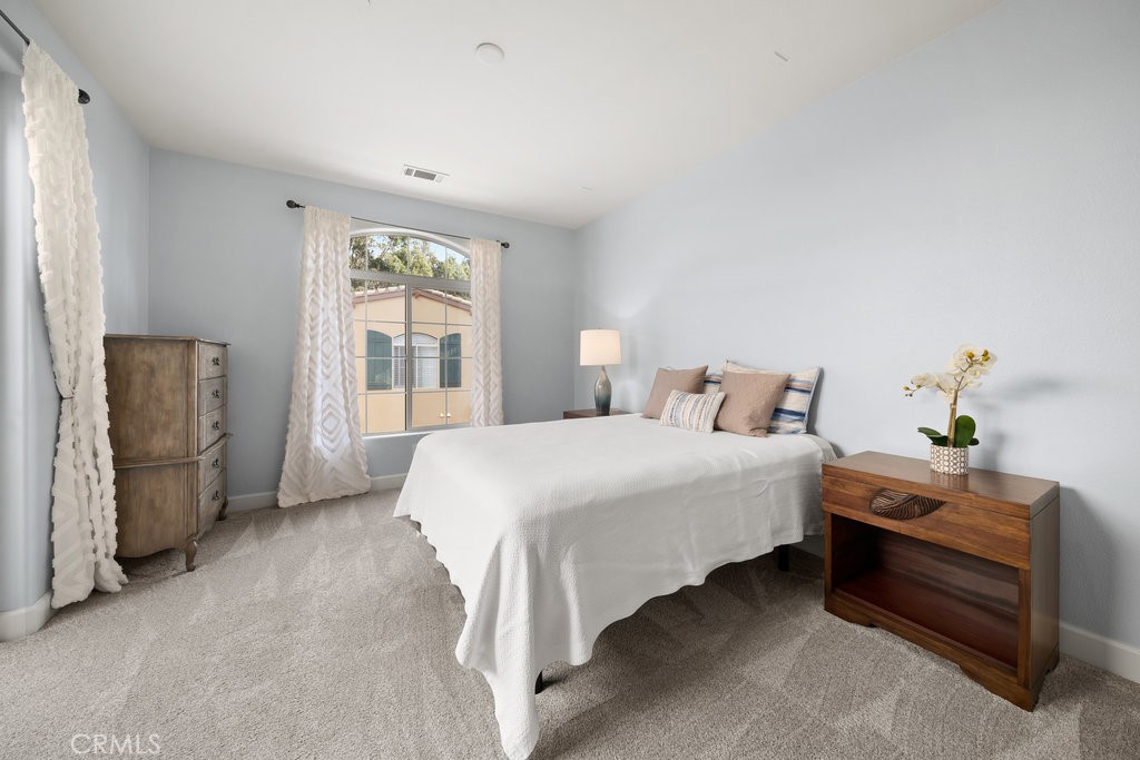 1156 Spring Azure Way Nipomo, CA 93444 - Photo 14 of 60 a bedroom with a bed table and window