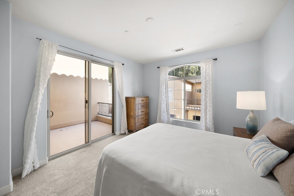 1156 Spring Azure Way Nipomo, CA 93444 - Photo 15 of 60 a bedroom with a large bed and a large window
