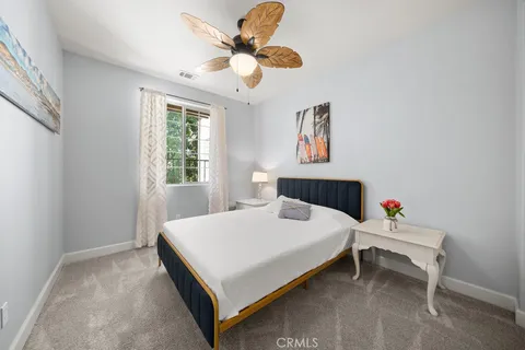 a bedroom with a bed and a chandelier