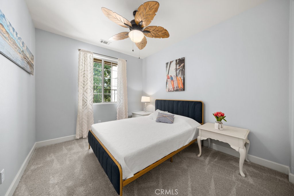 1156 Spring Azure Way Nipomo, CA 93444 - Photo 22 of 60 a bedroom with a bed and a chandelier