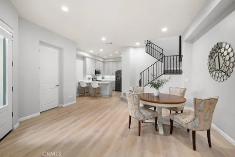 a dining room with furniture and wooden floor