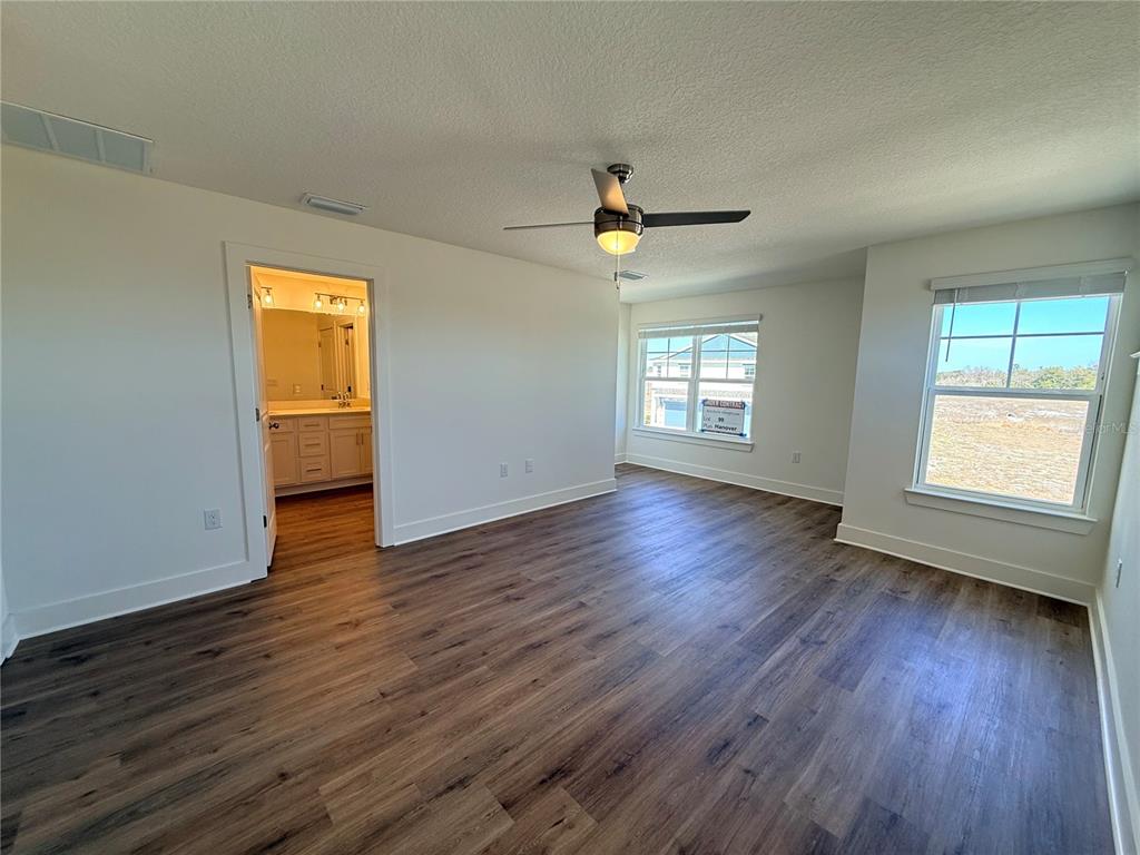 13622 Wolfpack Road Hudson, FL 34667 - Photo 3 of 7 a view of empty room with wooden floor and fan