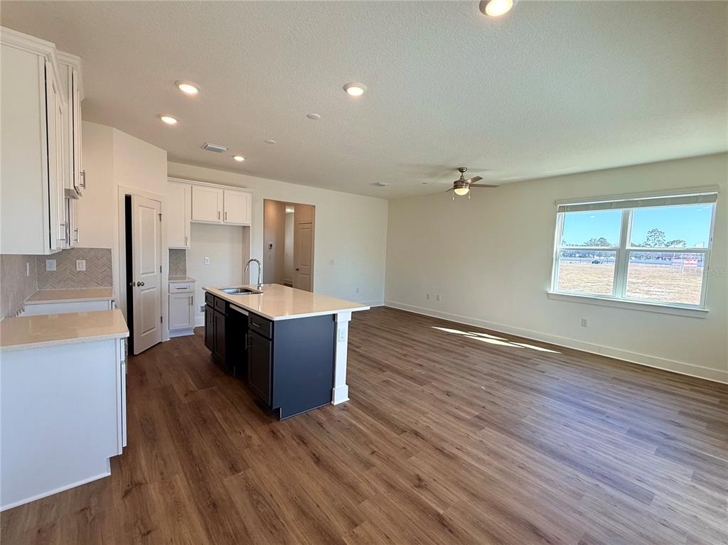 13622 Wolfpack Road Hudson, FL 34667 - Photo 5 of 7 a large kitchen with wooden floor and stainless steel appliances