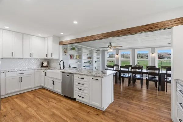 a kitchen with stainless steel appliances a stove refrigerator sink and cabinets