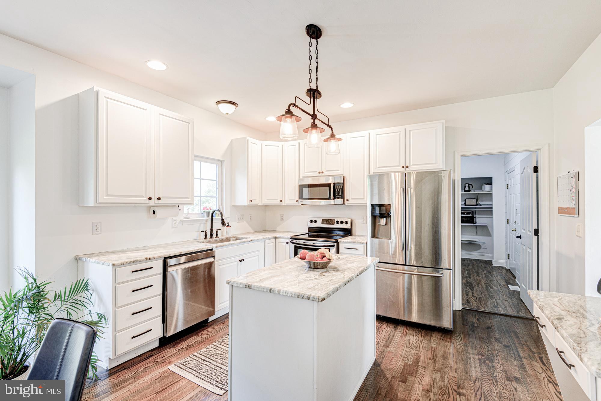 11 Basalt Street Townsend, DE 19734 - Photo 22 of 65 a kitchen with white cabinets and stainless steel appliances