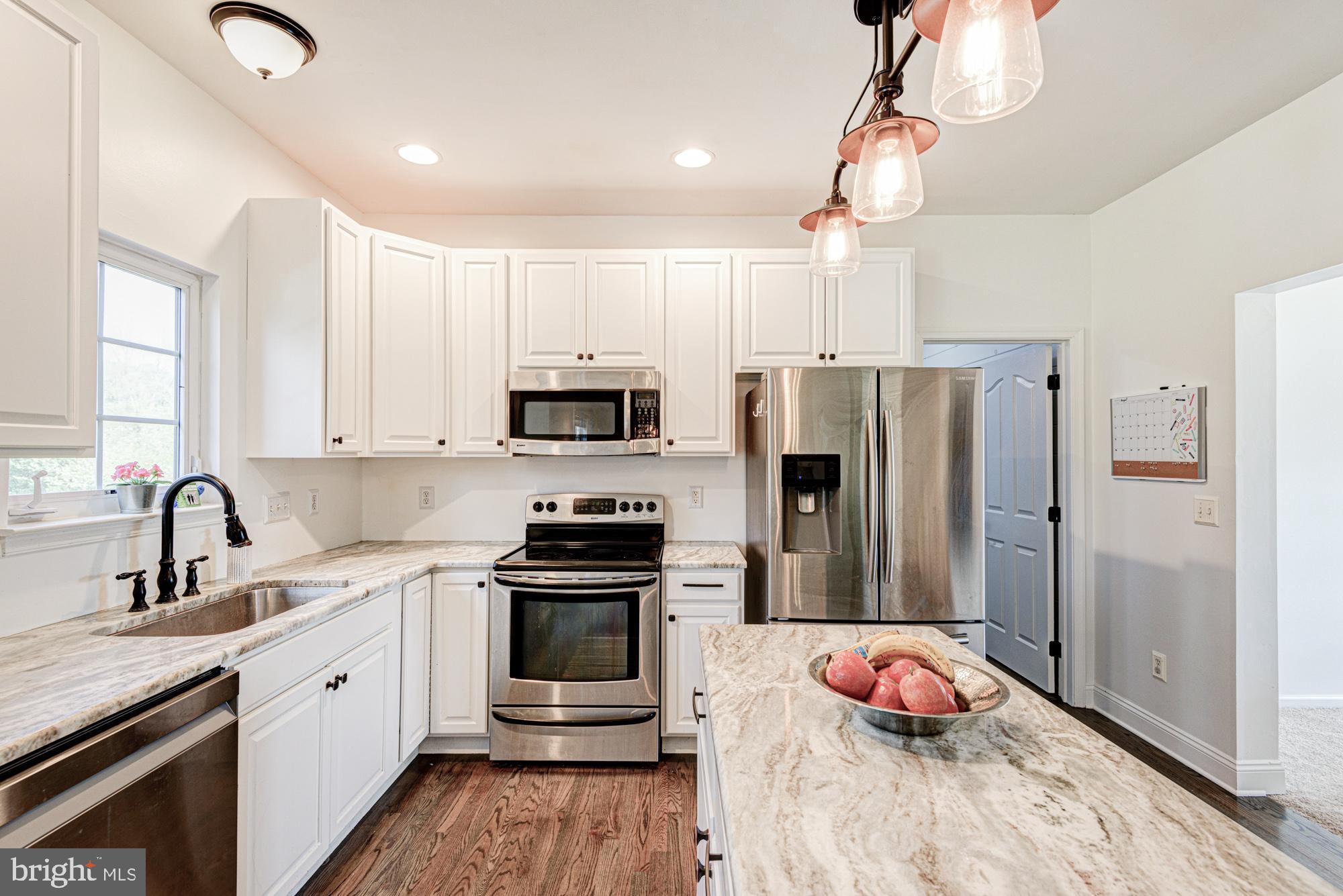 11 Basalt Street Townsend, DE 19734 - Photo 23 of 65 a kitchen with stainless steel appliances a sink stove and refrigerator