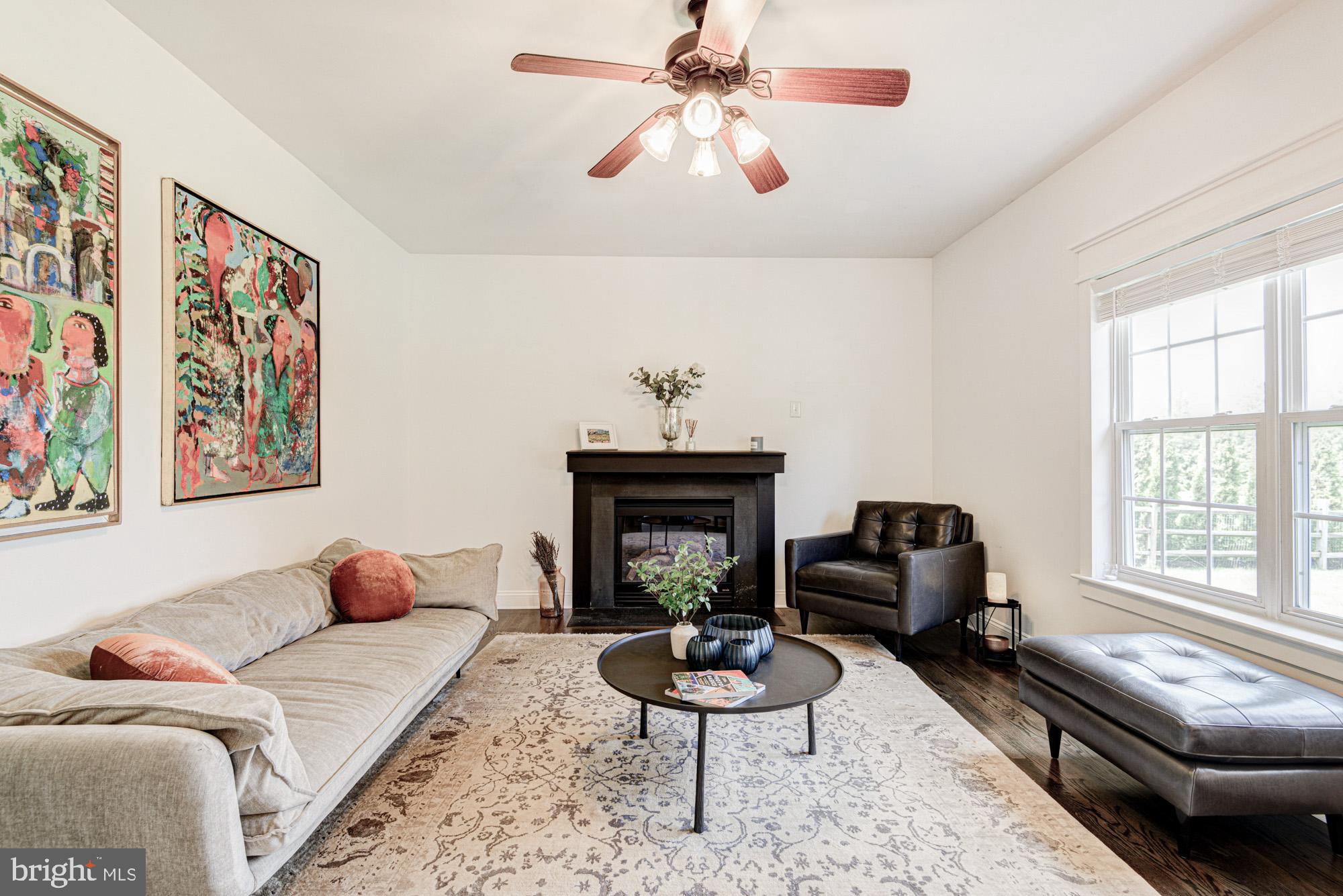 11 Basalt Street Townsend, DE 19734 - Photo 29 of 65 a living room with furniture a fireplace and a large window