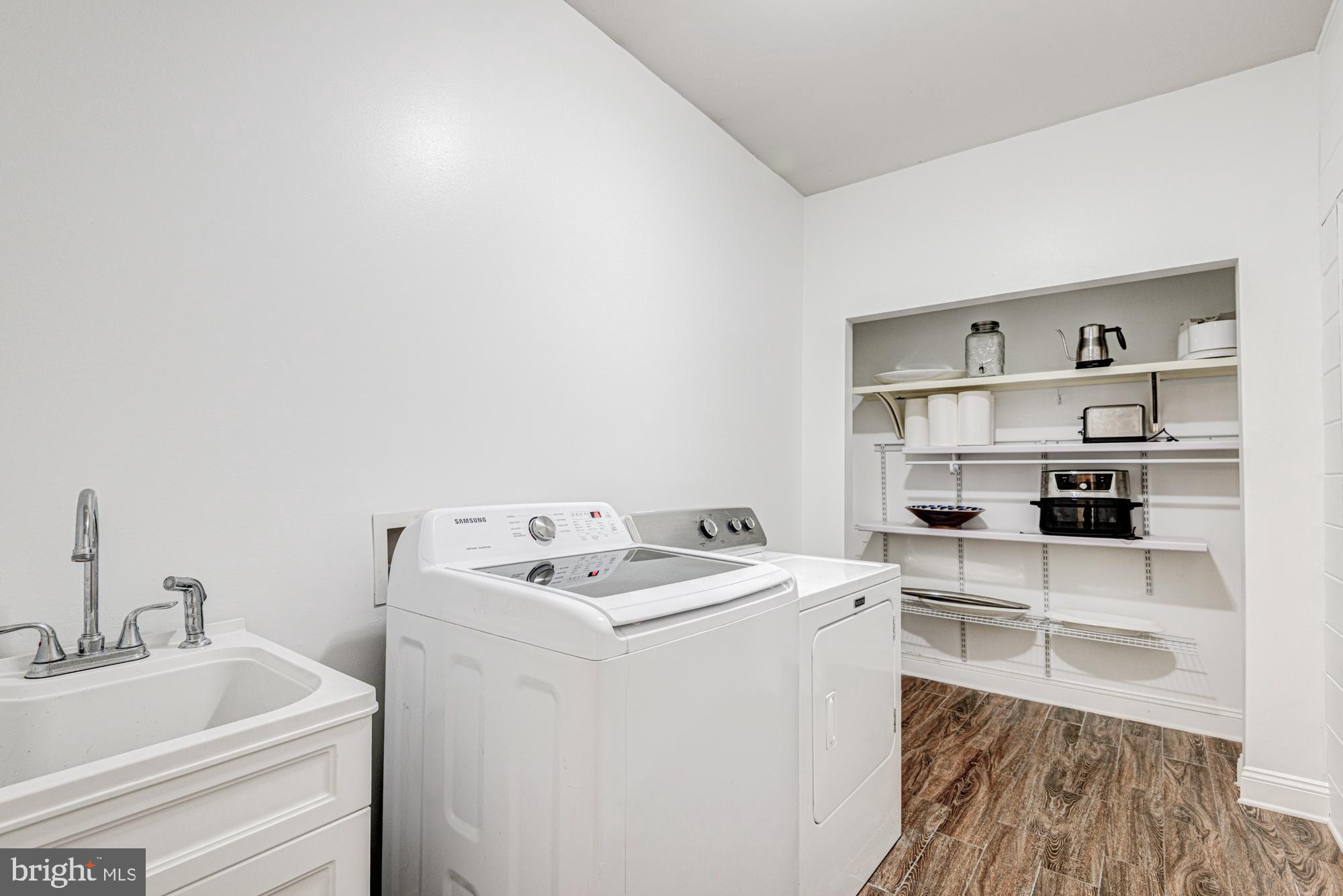 11 Basalt Street Townsend, DE 19734 - Photo 31 of 65 a view of washer and dryer with kitchen in the background