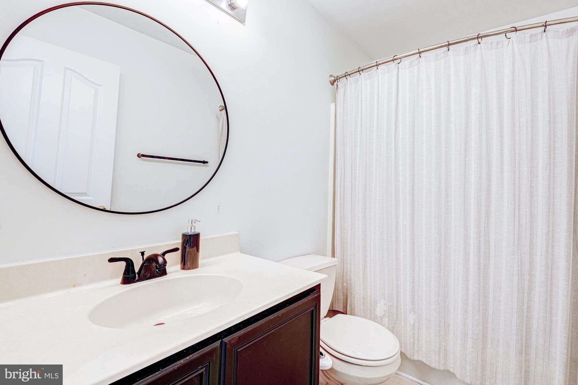 11 Basalt Street Townsend, DE 19734 - Photo 46 of 65 a bathroom with a sink a toilet and a mirror