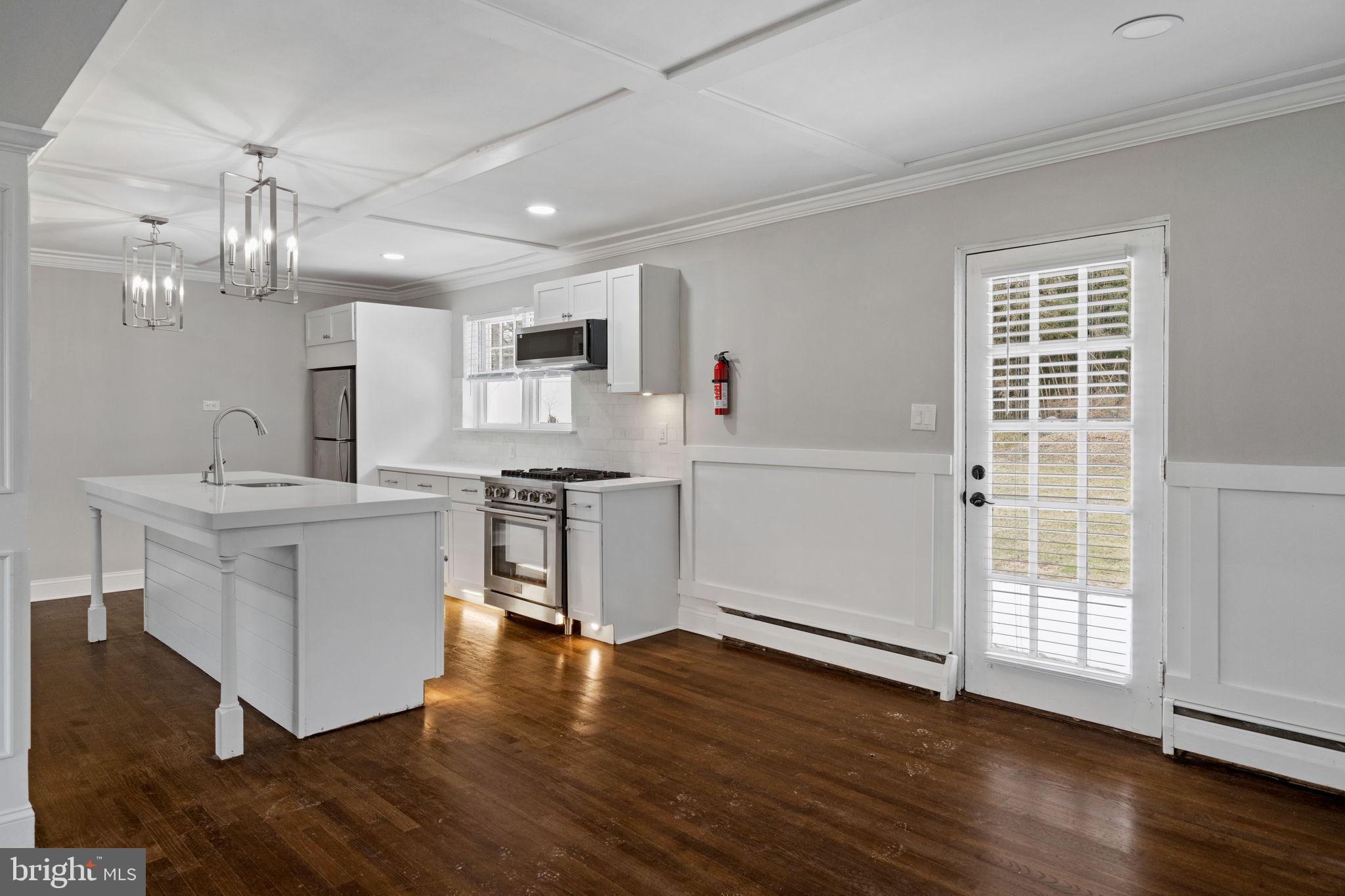 383 Upper Gulph Road Wayne, PA 19087 - Photo 13 of 42 a kitchen with a sink wooden floor and stainless steel appliances