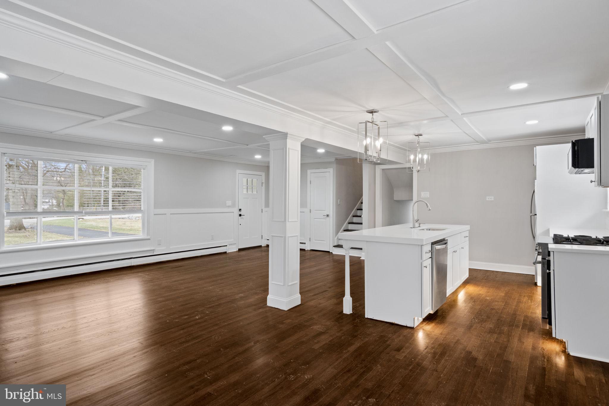 383 Upper Gulph Road Wayne, PA 19087 - Photo 14 of 42 a large white kitchen with wooden floors and white walls
