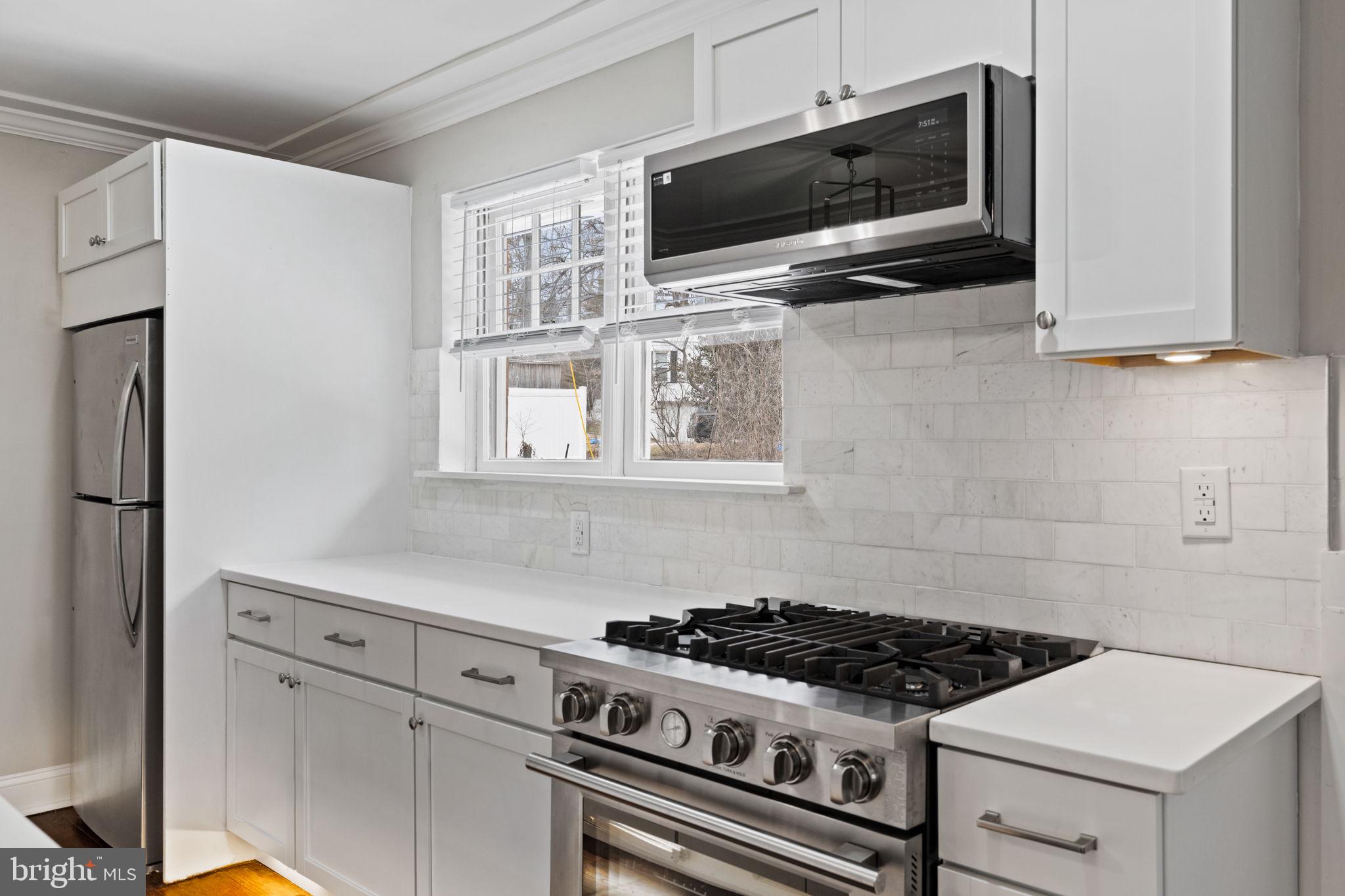 383 Upper Gulph Road Wayne, PA 19087 - Photo 16 of 42 a kitchen with microwave a stove and cabinets