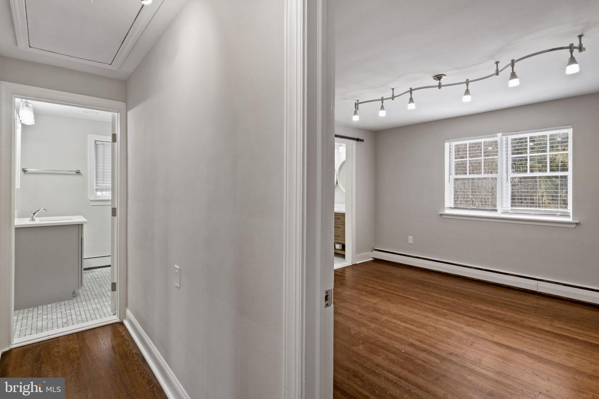 383 Upper Gulph Road Wayne, PA 19087 - Photo 20 of 42 a view of an empty room with wooden floor and a window