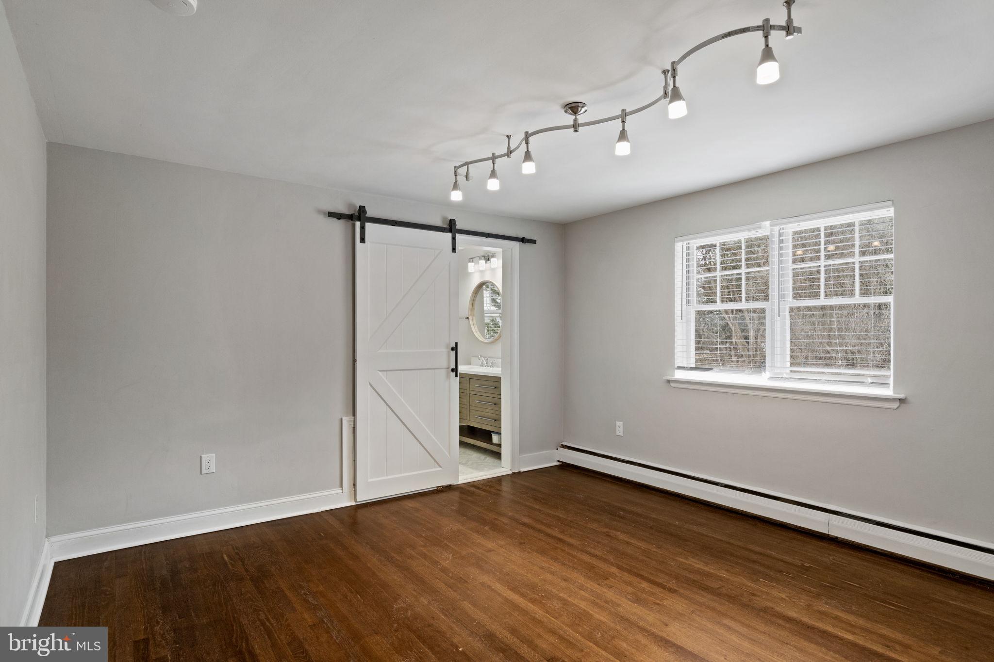 383 Upper Gulph Road Wayne, PA 19087 - Photo 21 of 42 a view of empty room with wooden floor and windows