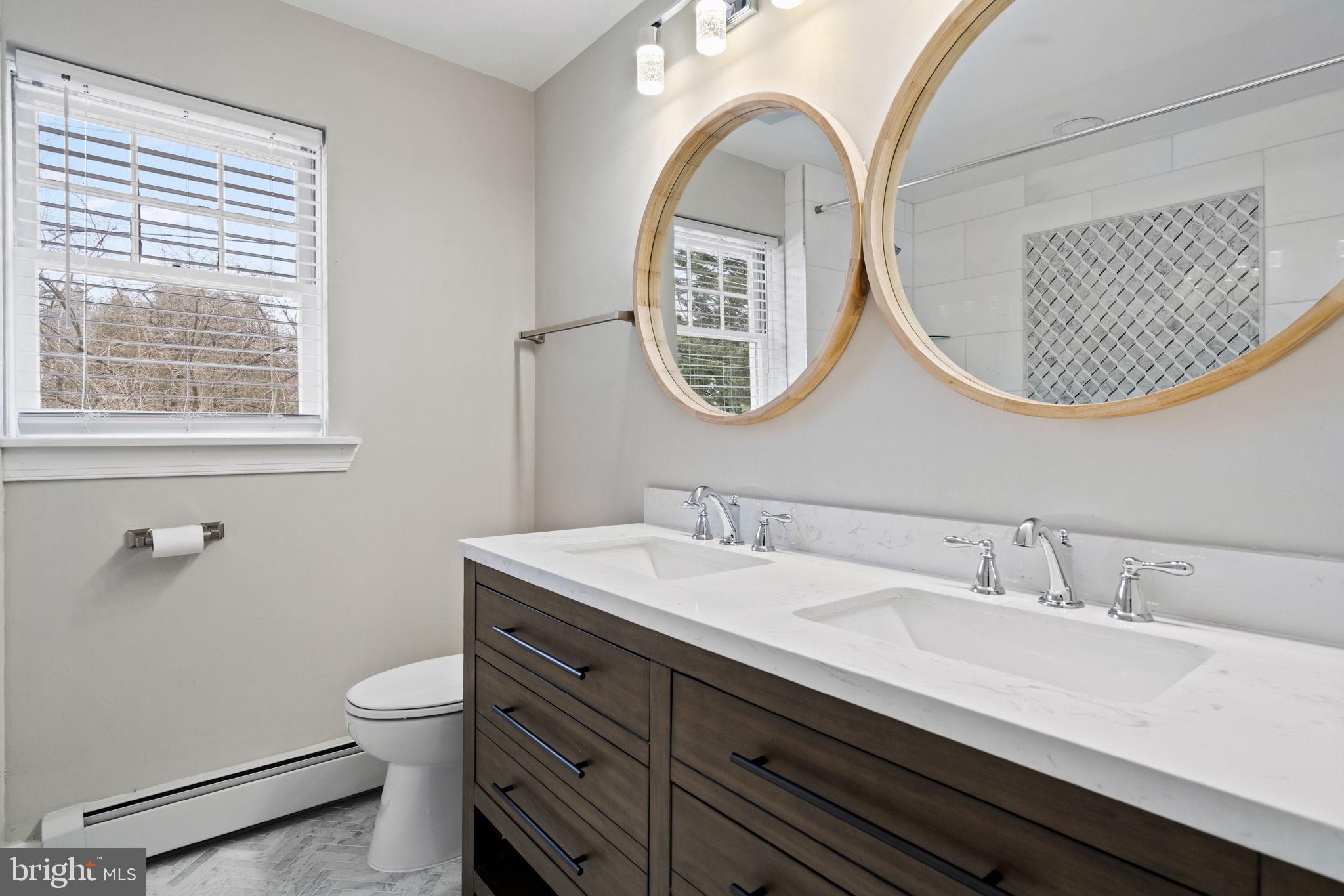 383 Upper Gulph Road Wayne, PA 19087 - Photo 25 of 42 a bathroom with a toilet a sink and a mirror