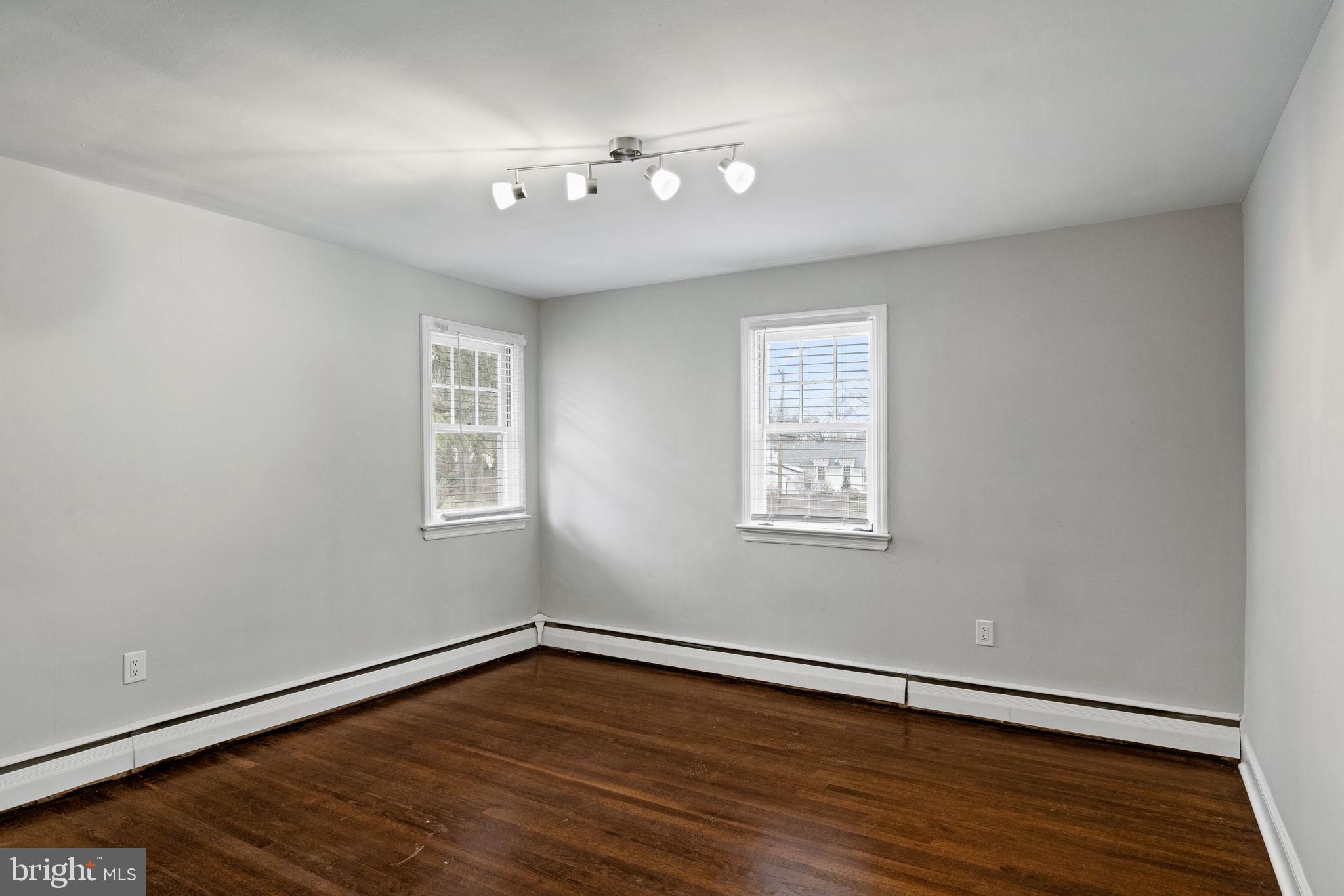 383 Upper Gulph Road Wayne, PA 19087 - Photo 28 of 42 a view of an empty room with wooden floor and a window