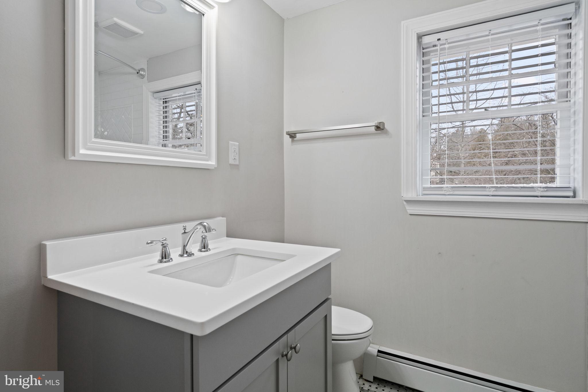 383 Upper Gulph Road Wayne, PA 19087 - Photo 32 of 42 a bathroom with a sink a toilet and a window