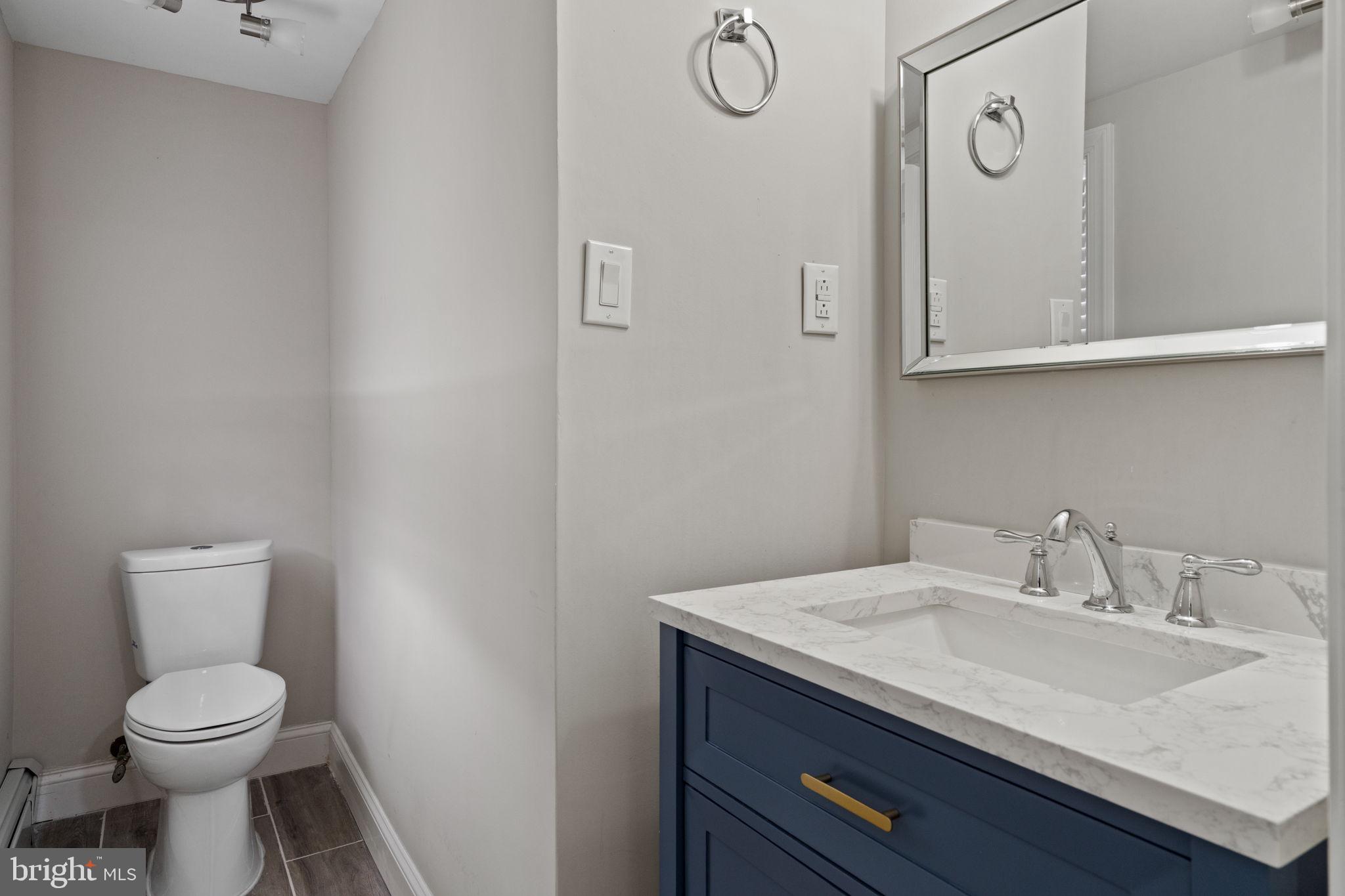 383 Upper Gulph Road Wayne, PA 19087 - Photo 35 of 42 a bathroom with a granite countertop toilet sink and mirror