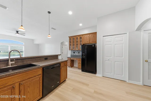 a kitchen with stainless steel appliances granite countertop a sink and refrigerator