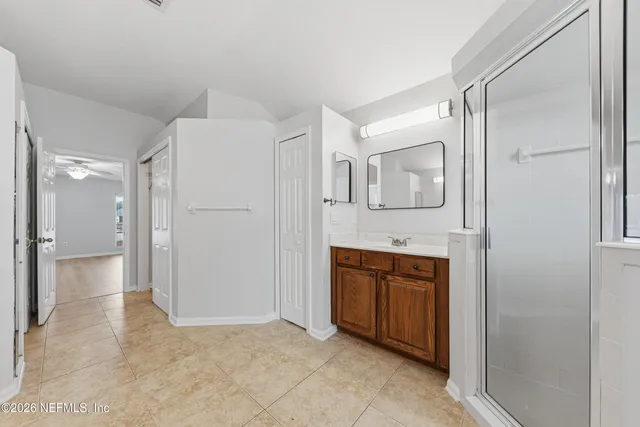 a spacious bathroom with a shower and a sink