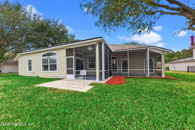 a view of a house with backyard and porch