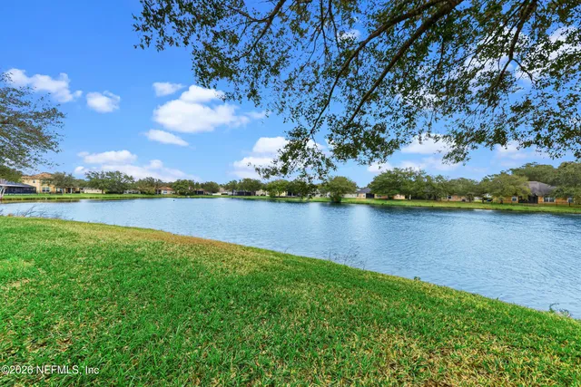 a view of a lake with houses in the back