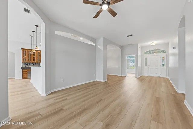 a view of empty room with wooden floor