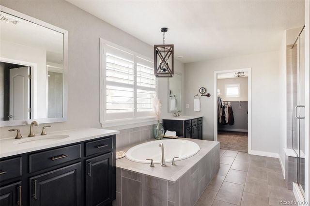 a spacious bathroom with a granite countertop tub sink and mirror