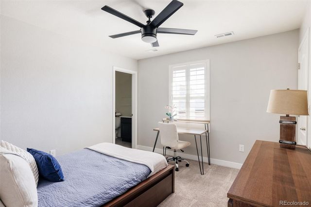 a bedroom with a bed and a table in it