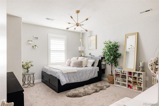 a bedroom with a bed potted plant and a window