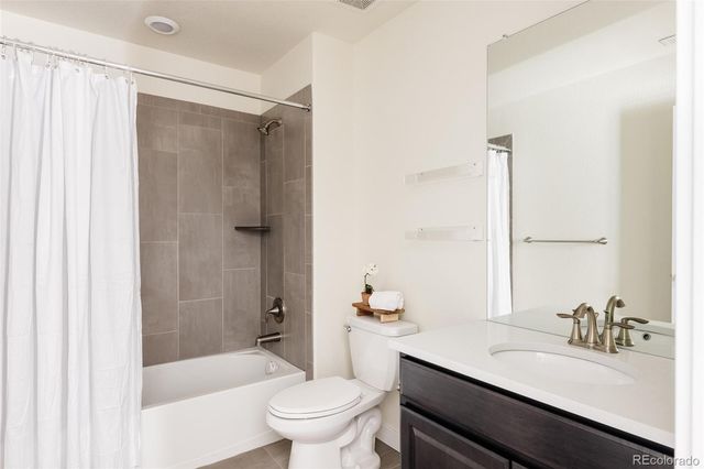 a bathroom with a sink toilet vanity and shower