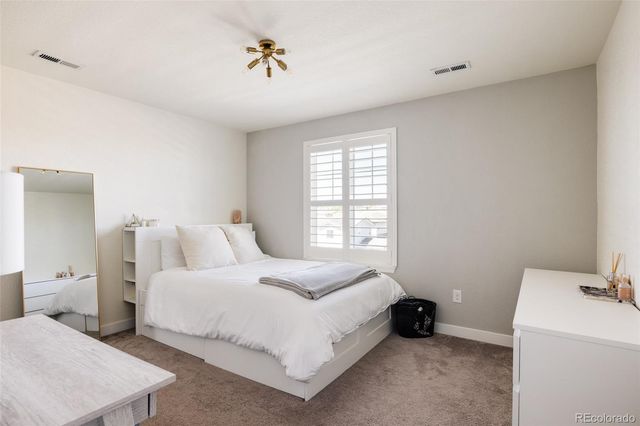 a bedroom with a bed and a table