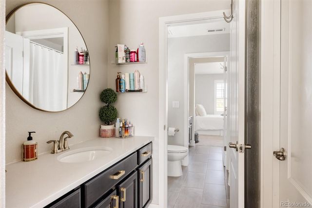 a bathroom with a sink vanity and a mirror