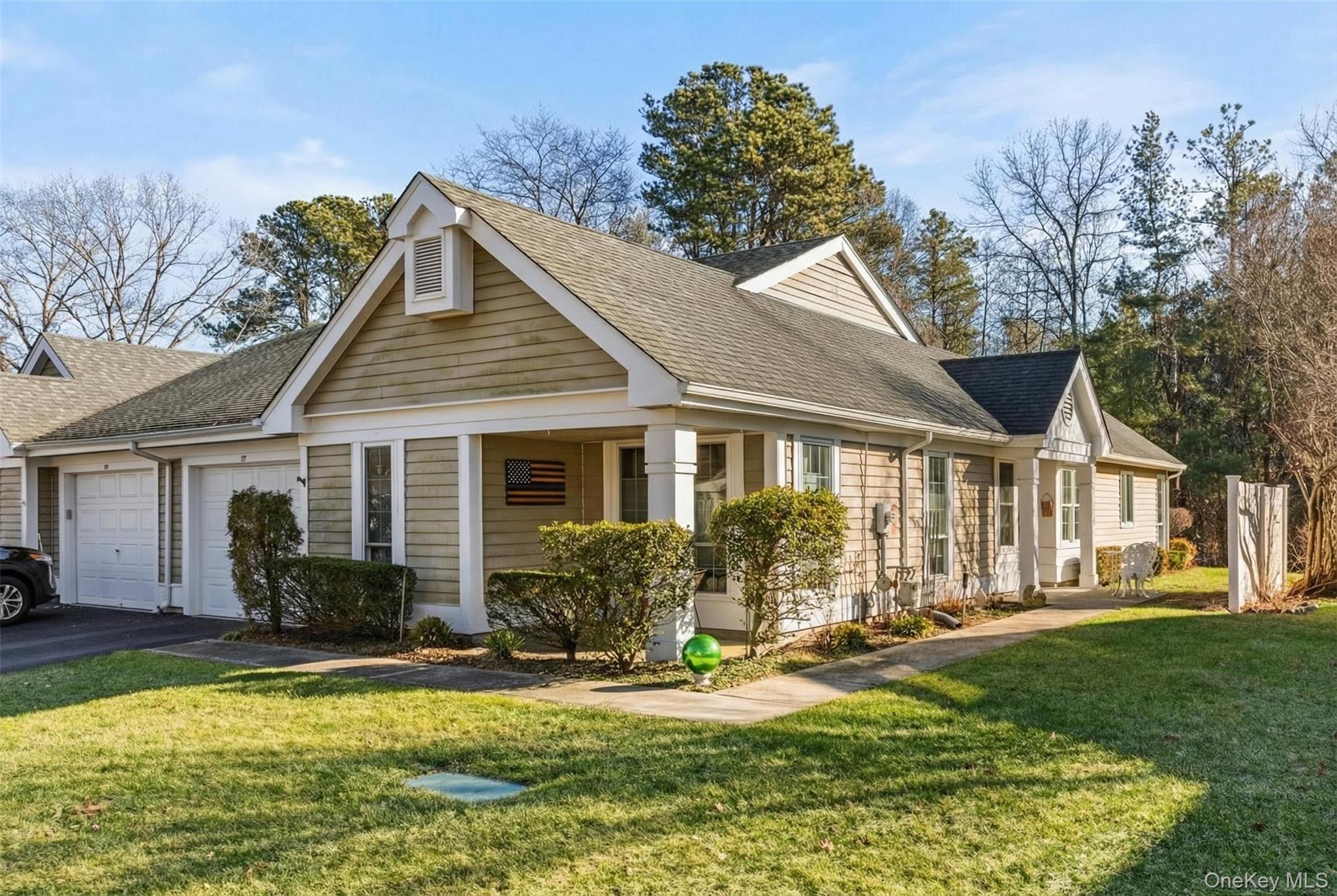 77 Glen Drive Ridge, NY 11961 - Photo 4 of 27 a front view of house with yard and trees in the background